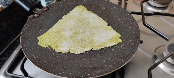 Place the rolled paratha on Tawa