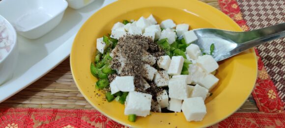 Put Hung curd, chopped Capsicum, Onion, Paneer, Salt and Pepper;