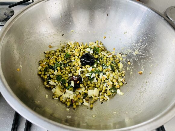 Put off the flame decorate with remaining grated coconut.