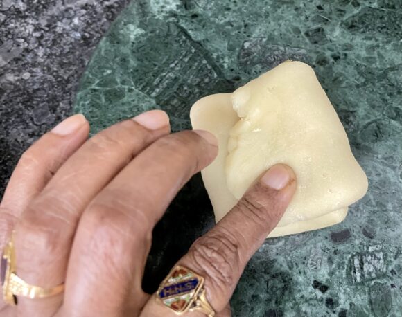 Apply ghee and fold once more three fold (total 9 fold)