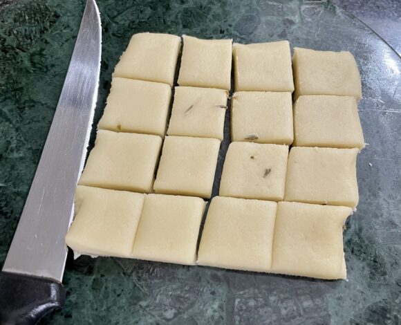 With a knife cut in square shapes, as shown in the photo