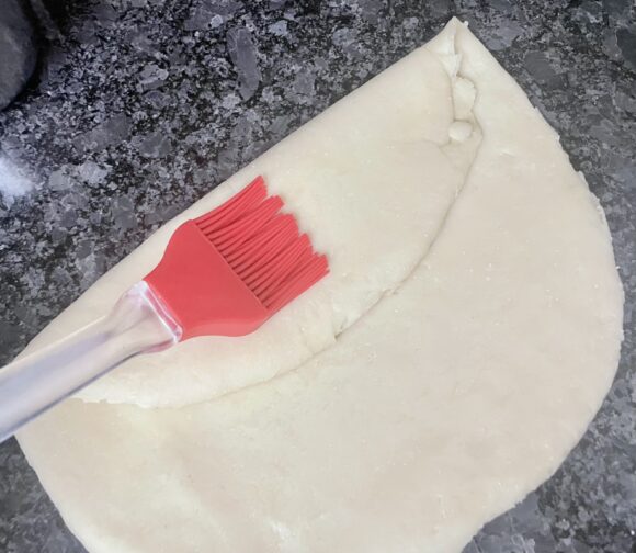 Apply ½ teaspoon of ghee, fold as shown in the photo