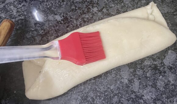 Apply ghee and fold once more three fold (total 9 fold)