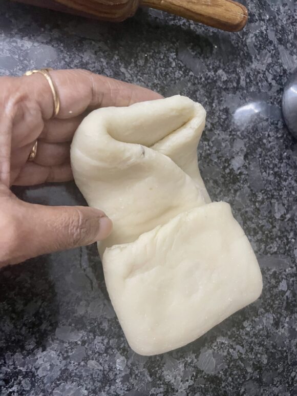 Apply ghee and fold once more three fold (total 9 fold)