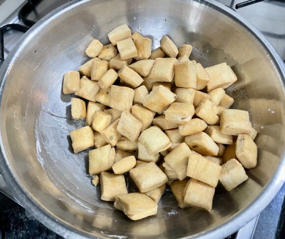 Dip this fried square  pieces into the sugar syrup