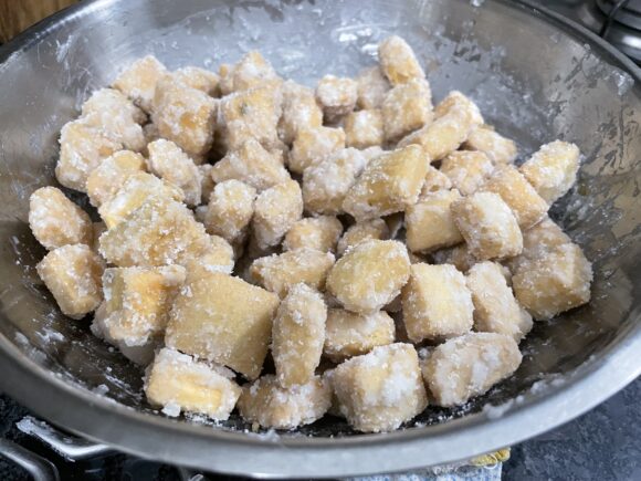 continuously stir and toss well, so that all the Shakkarpare are coated with the sugar syrup properly.