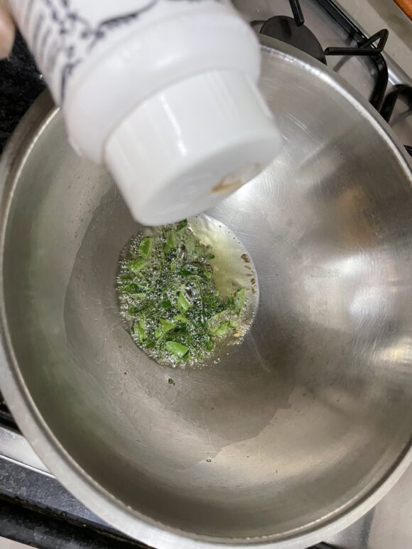 add asafoetida, green chilli and curry leaves