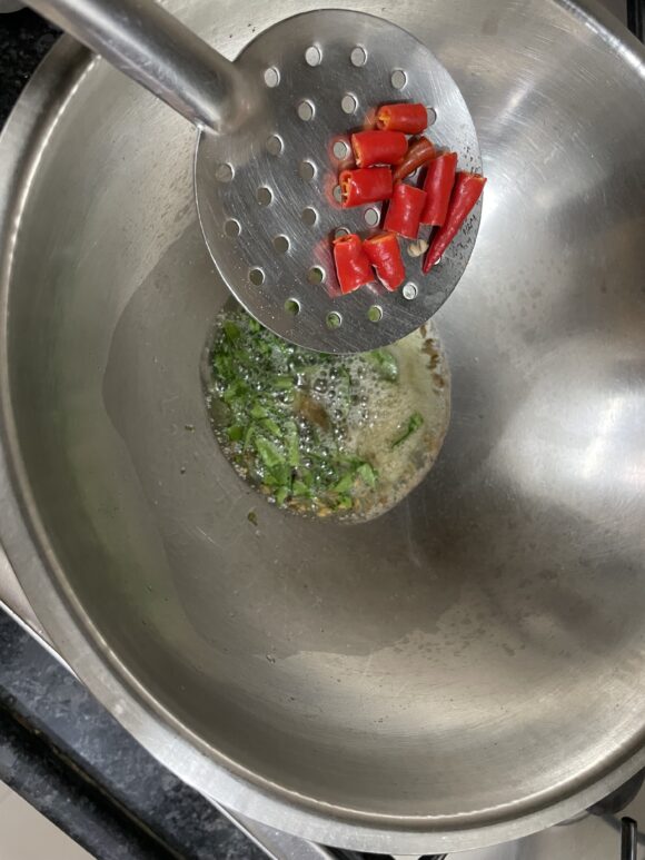 add asafoetida, green chilli and curry leaves