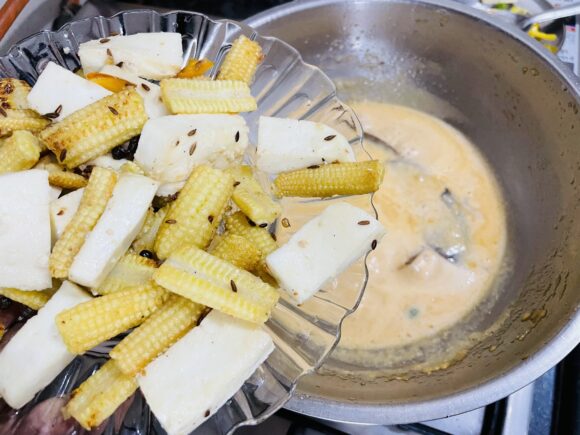 Add fried baby corn, paneer and green chilli