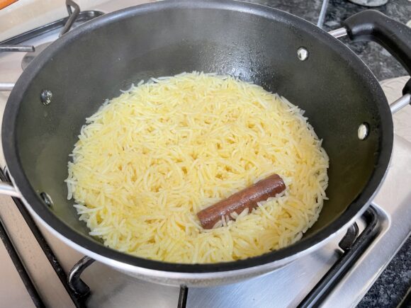 Cover with lid; cook on low flame until the rice is tender