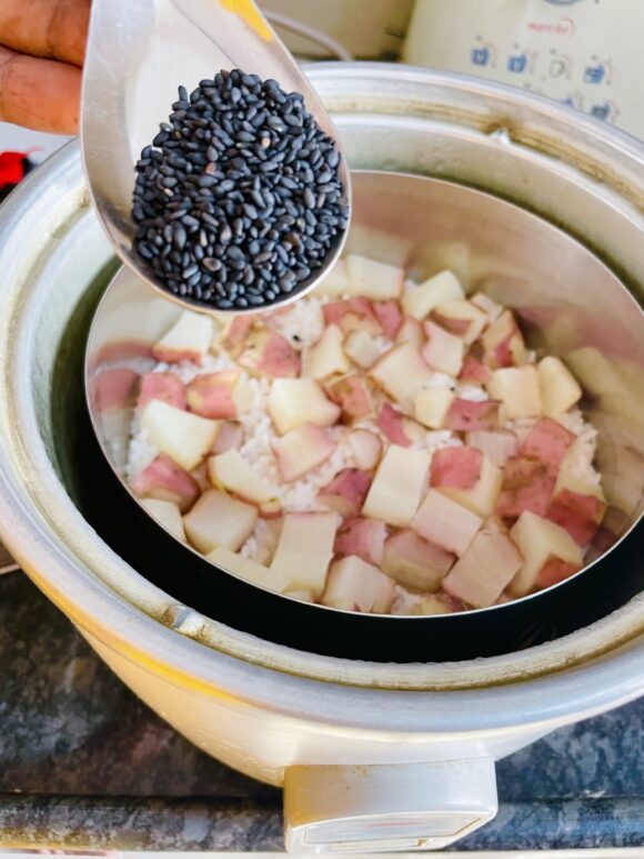 Add butter and roasted sesame seed in hot cooked rice