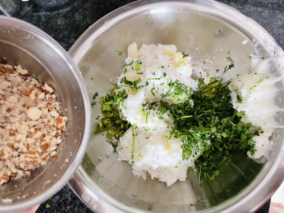 Add salt, roughly grind almond, chopped green chilli and coriander leaves; make dough