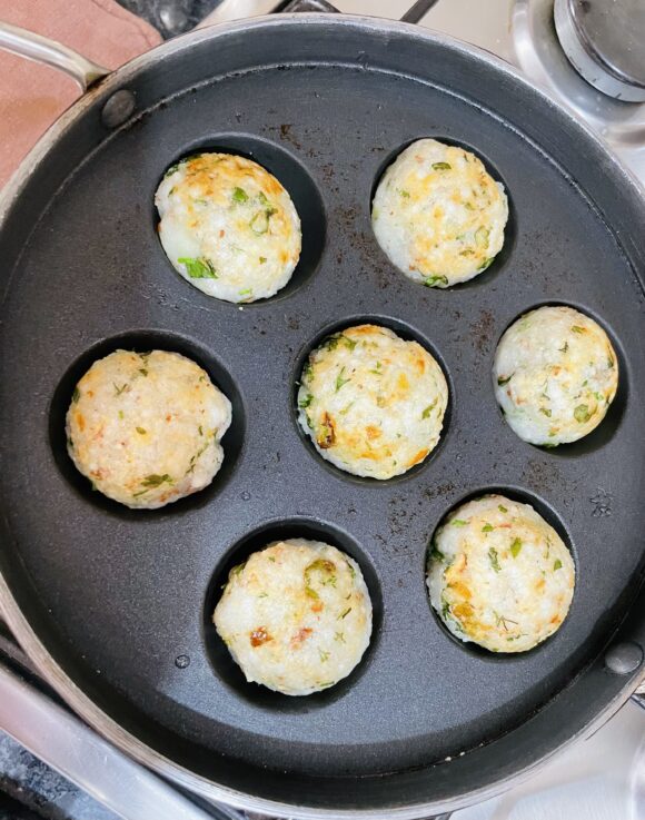 grease the Paniyaram pan, cook until light golden colour appears all around.
