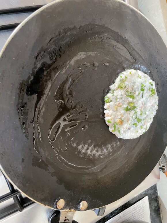 On nonstick griddle/Tawa; patting over oiled Tawa till it become 3-4 inch