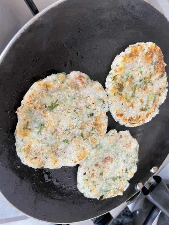 On nonstick griddle/Tawa; patting over oiled Tawa till it become 3-4 inch