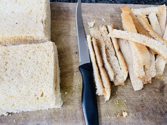 Discard the crust (brown edges) of bread slices; cut bread slices into two part