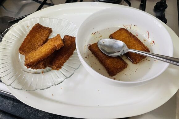 Put the fried bread into sugar syrup