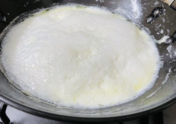 Once the milk reduces half in quantity; add sugar,